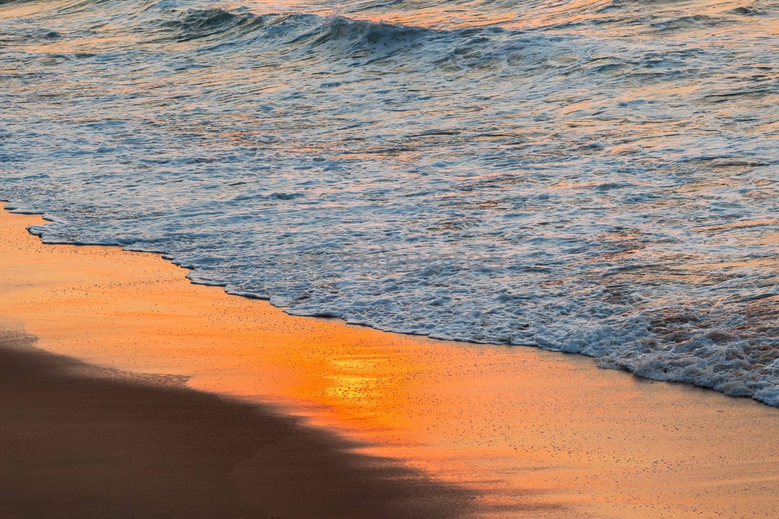 Beach sands waterline shoreline sunrise color mirror sunlight reflections of ocean water nature