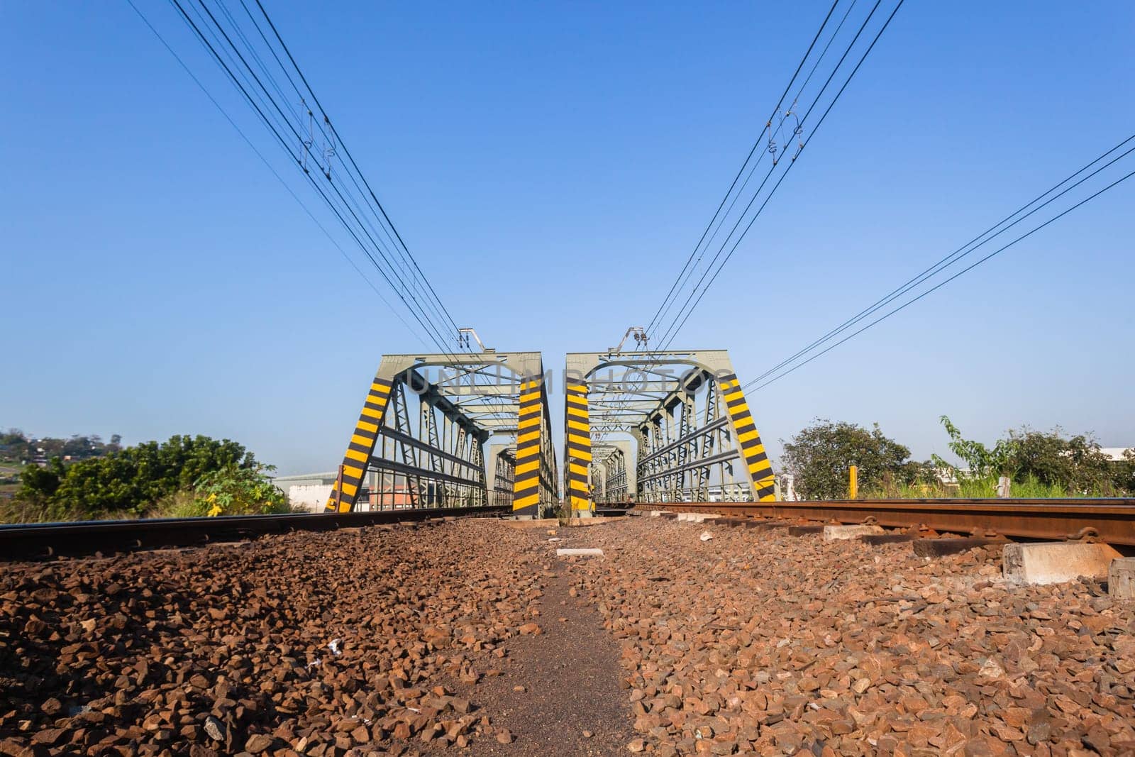 Railway bridge closeup steel tracks structure river crossing city countryside route.