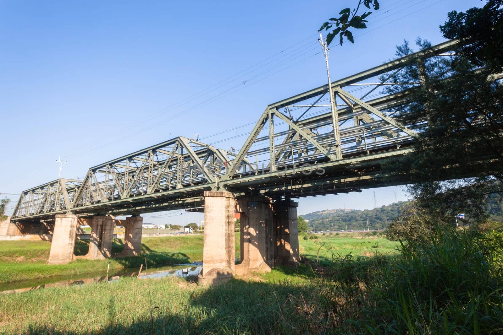 Railway bridge closeup steel tracks structure river crossing city countryside route.