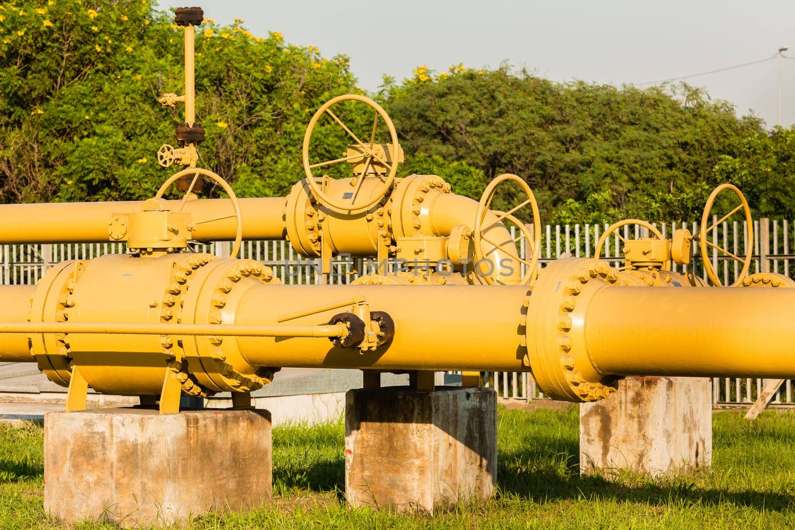 Pipeline yellow steel structure with mechanical valves outdoors for fuel liquids supply line..