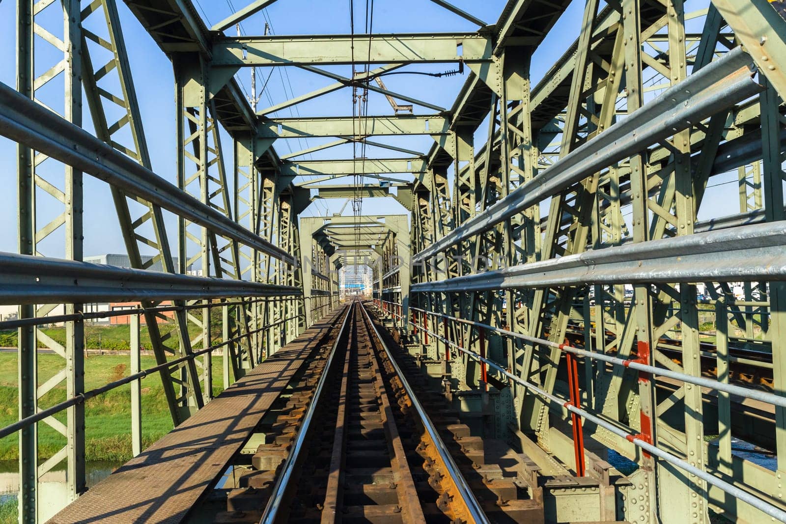 Railway bridge closeup steel tracks structure river crossing city countryside route.