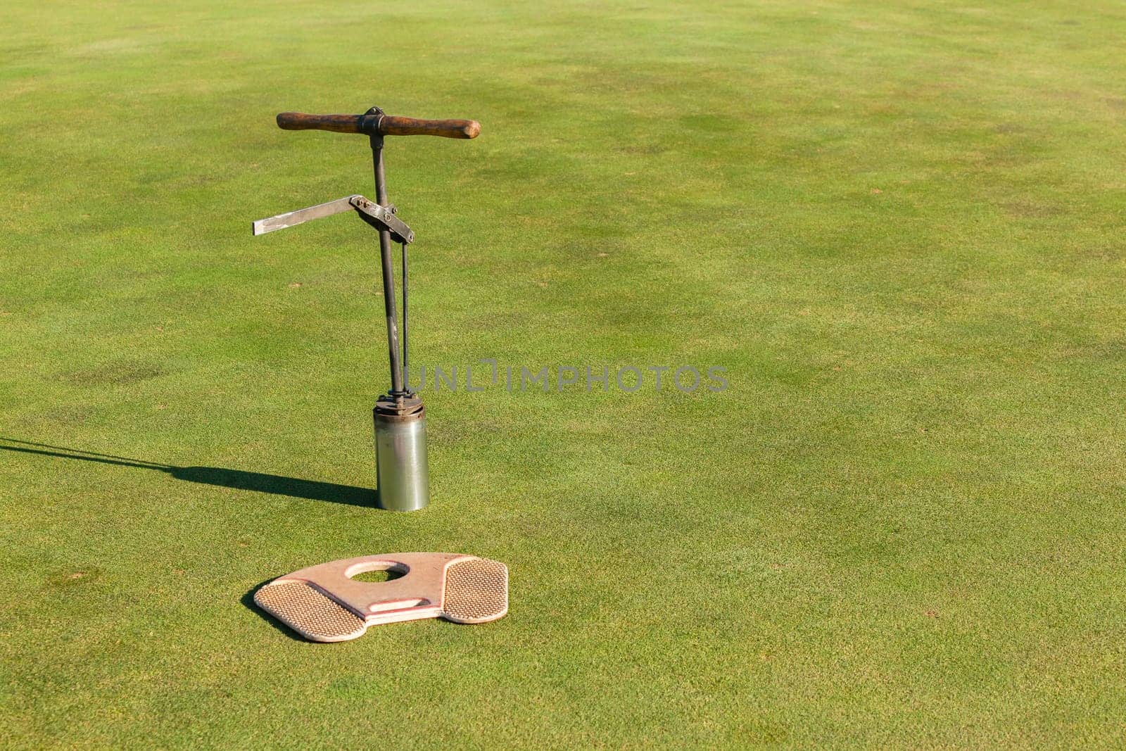 Golf course hole flag stick putting green fairway closeup abstract sporting landscape..