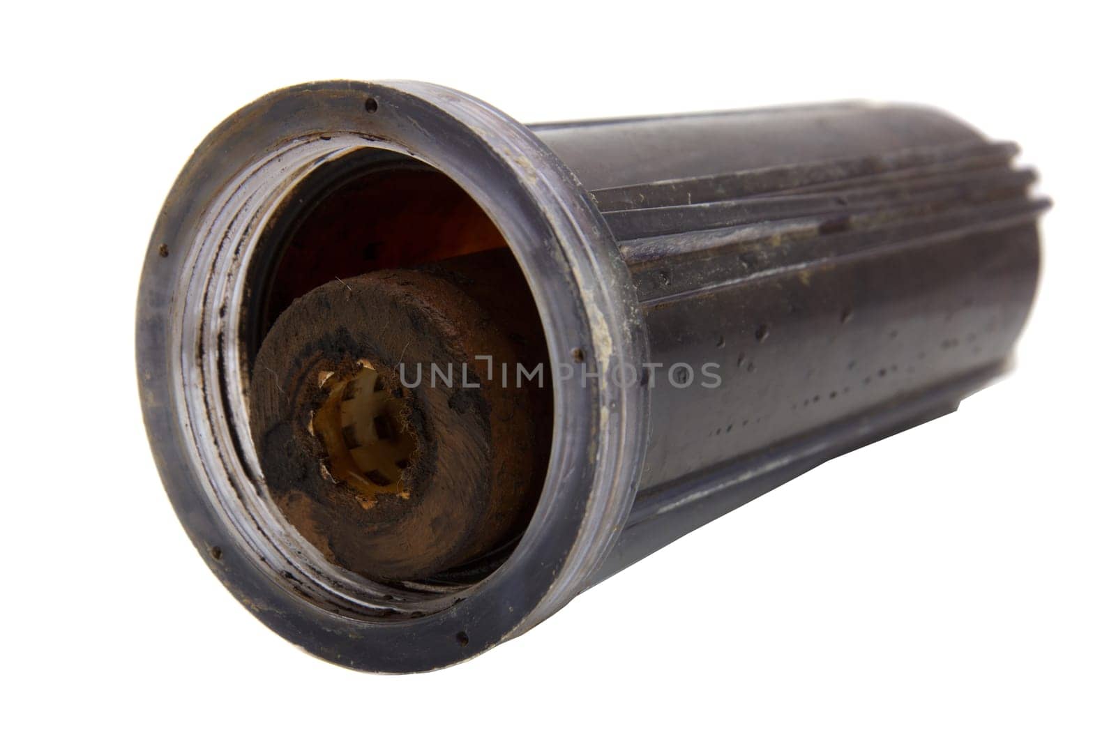Old dirty water filter in plastic holder isolated on white background