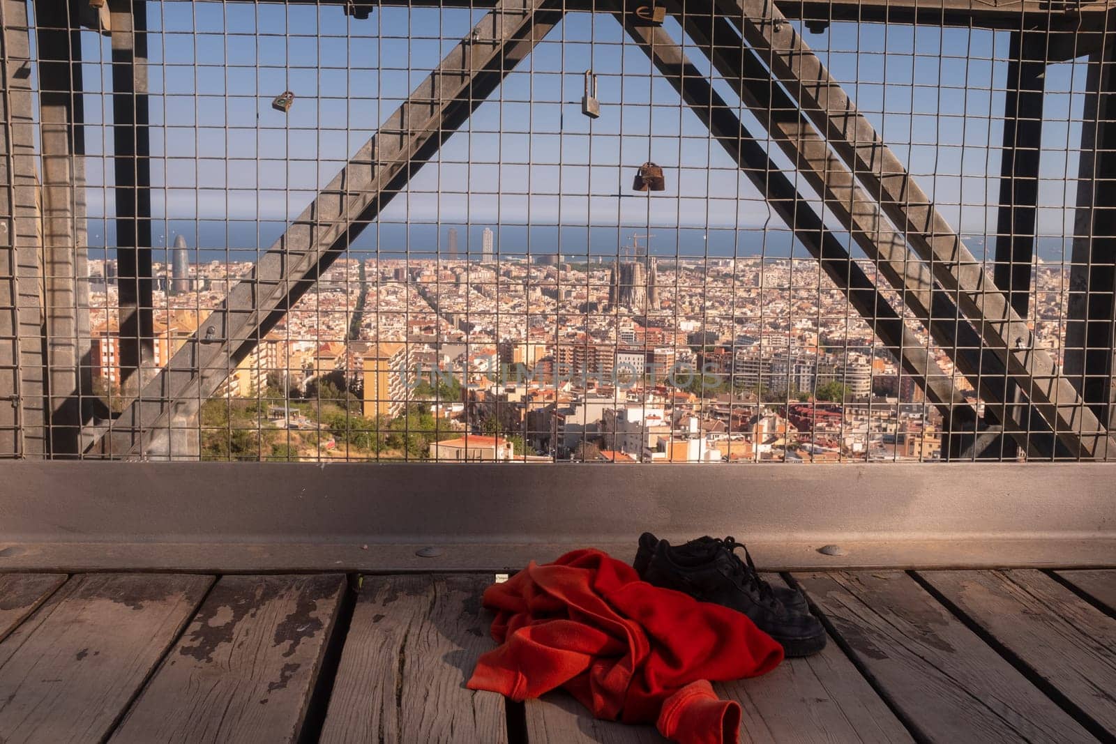Sweatshirt and shoes of a girl who could have committed suicide by jumping off a bridge, concept stop teenage suicide, the city of Barcelona in the background