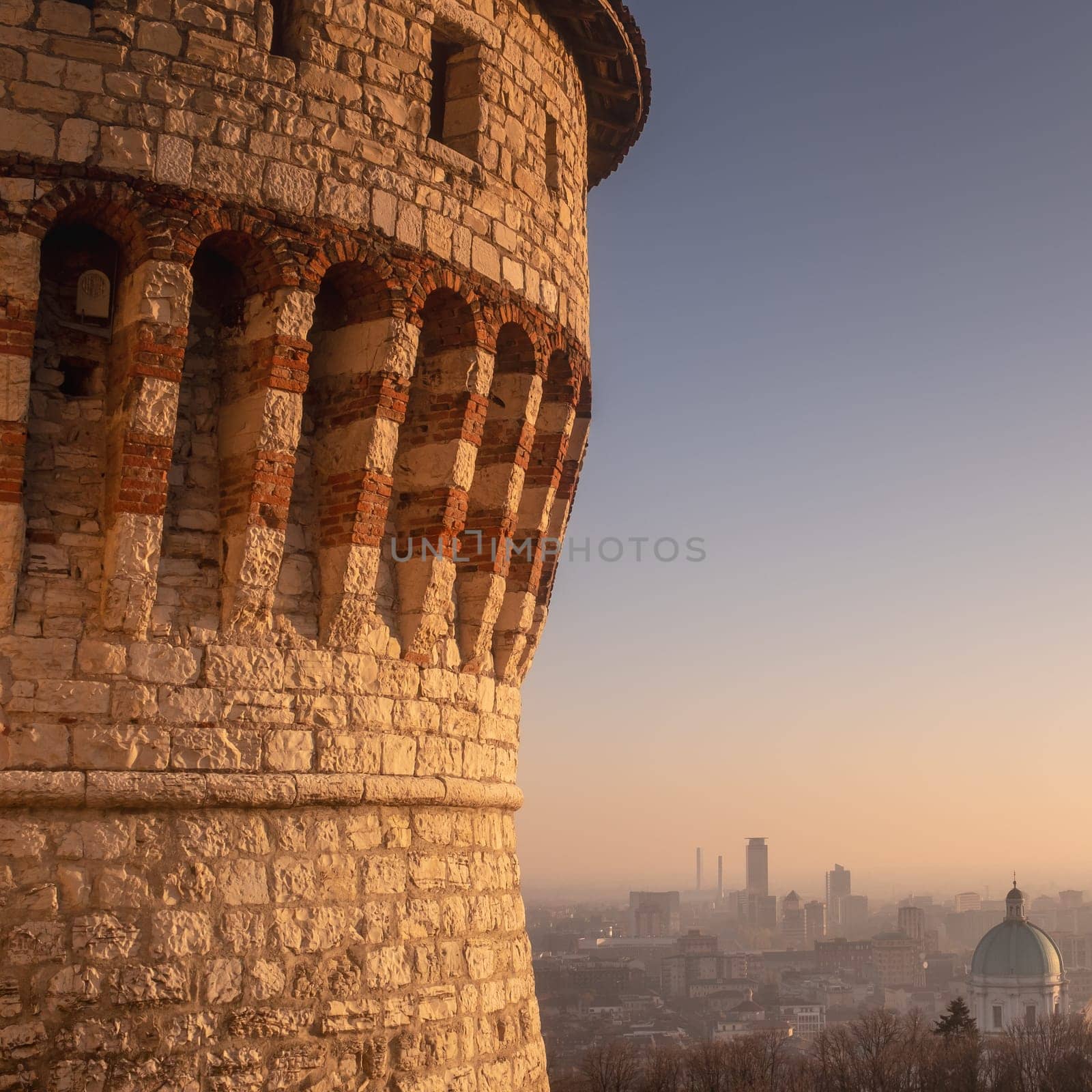 A view of Brescia from the Medieval Castle, with the dome of the Cathedral and the skyscrapers of the modern city, at sunset