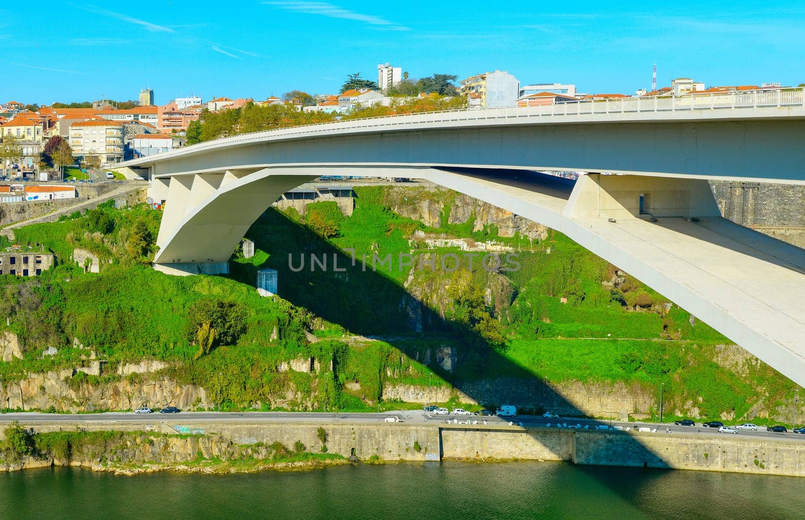 Panorama of Porto downtown with Arrabida Bridge by Douro river in bright sunny day, Portugal