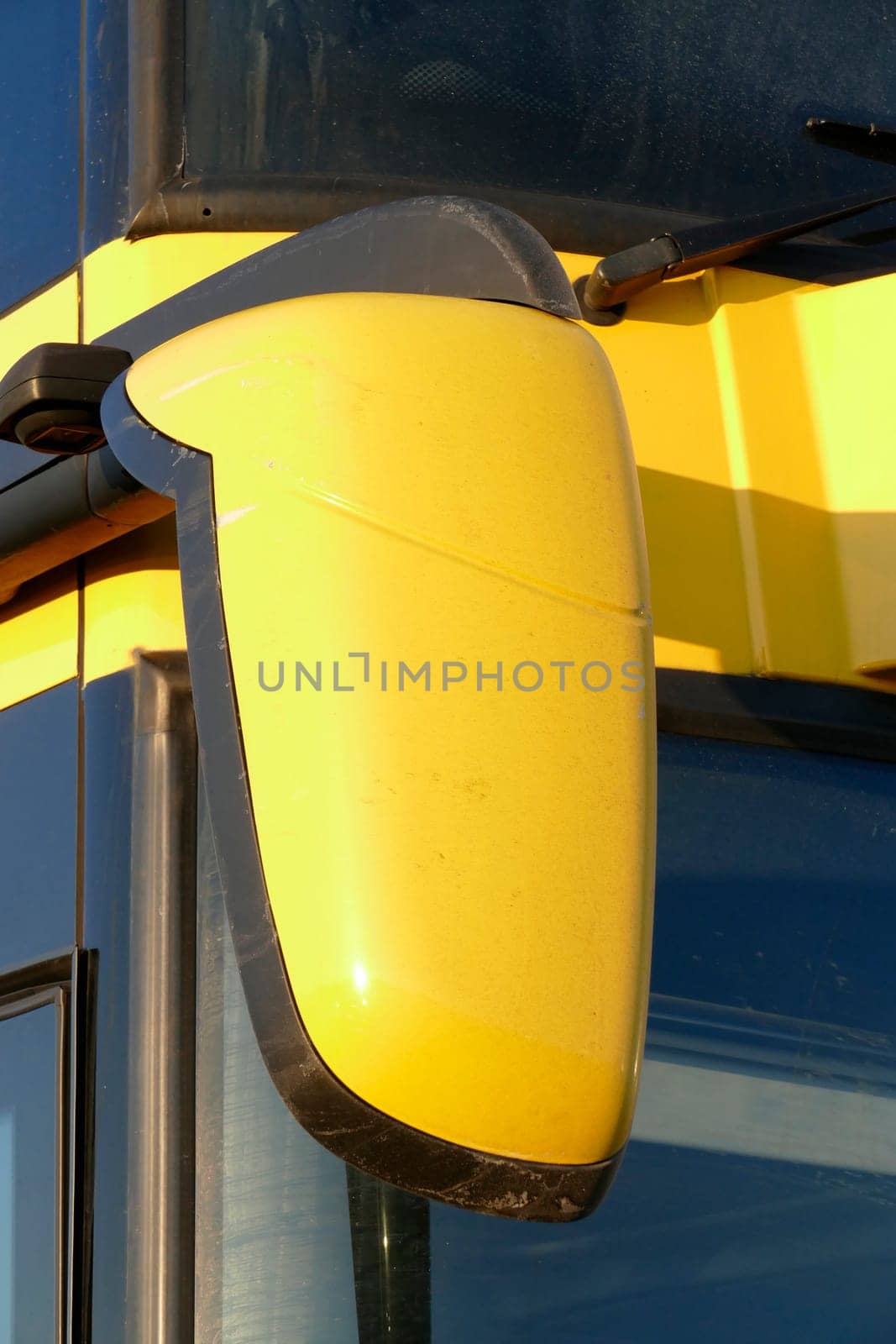 Yellow rearview mirror on a coach