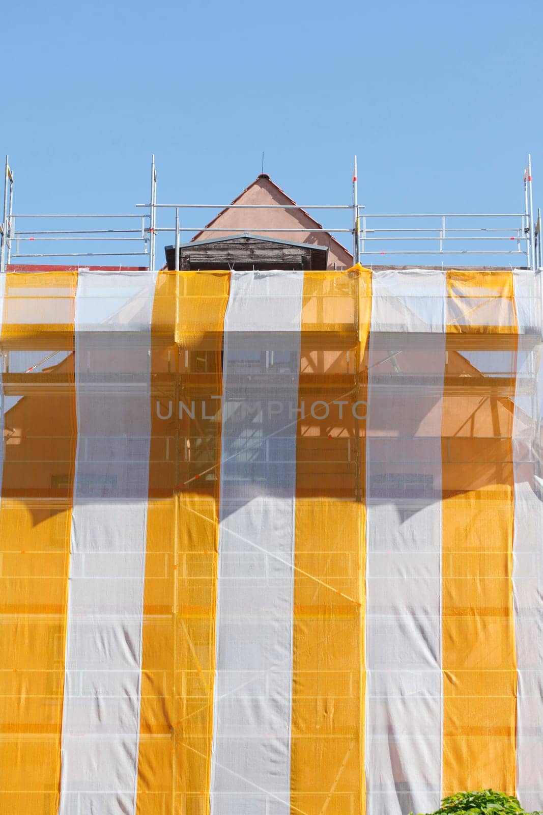 Orange-white tarpaulin, gable, scaffolding, construction site, house facade, old building, Germany, Europe