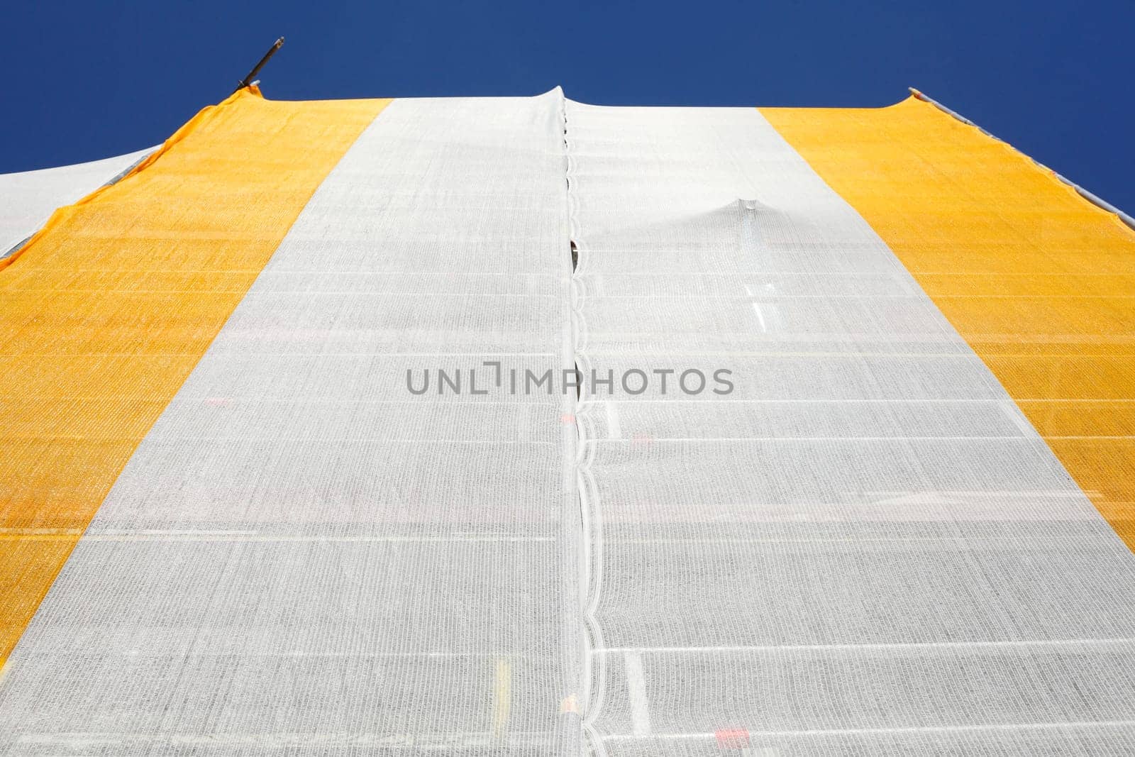 Orange-white tarpaulin, gable, scaffolding, construction site, house facade, old building, Germany, Europe