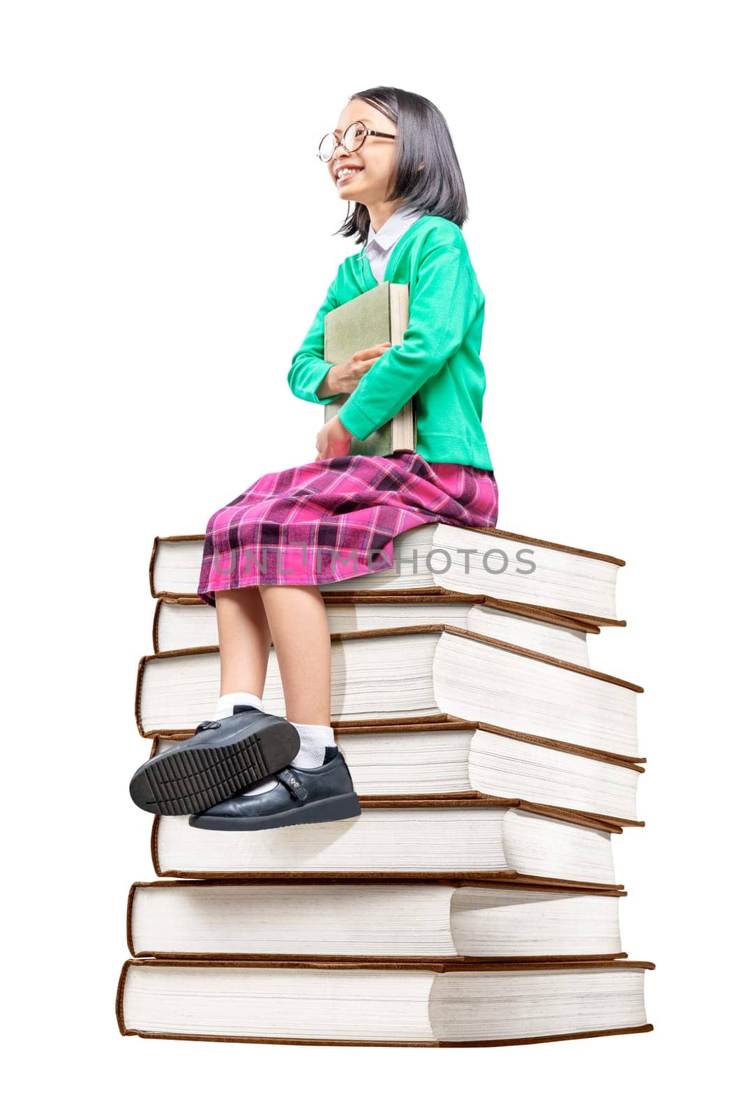 Asian cute girl with glasses holding the book while sitting on the pile of books isolated over white background. Back to School concept