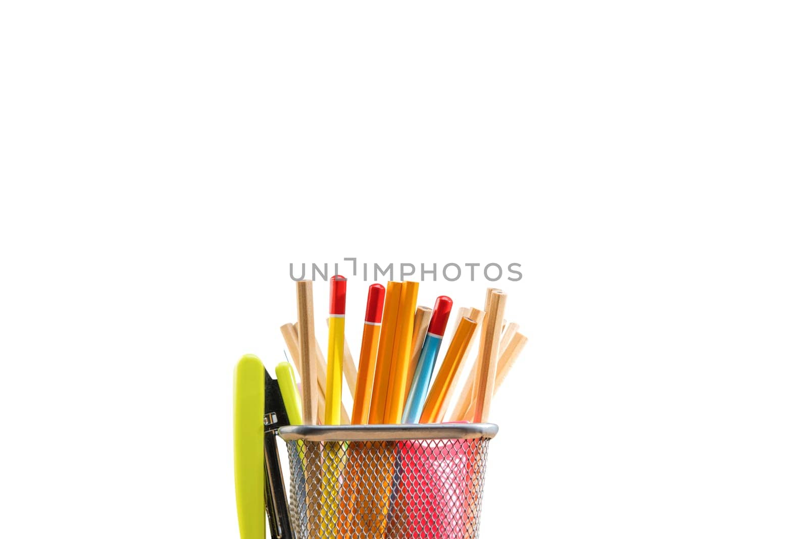Pencils in basket container with green stapler isolated over white background. Back to School concept