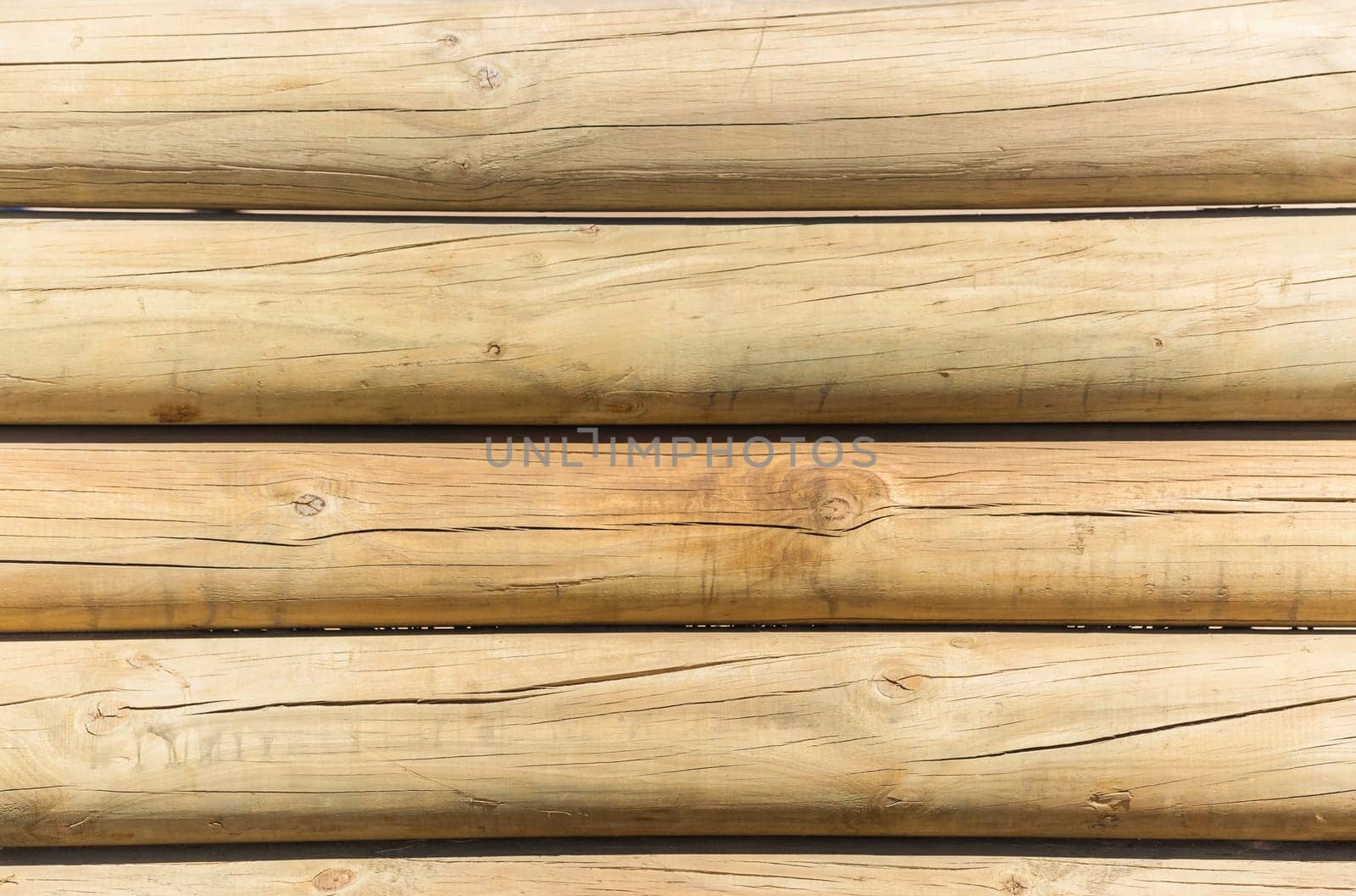 Wood poles low boundary fence wall decor outdoors closeup photo against blue sky