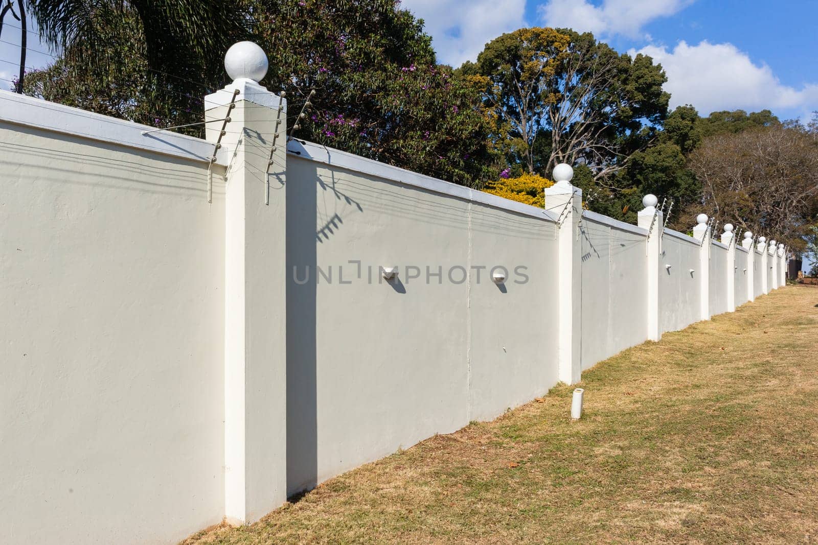 Boundary Wall high closeup with Electrified Fence for security in countryside