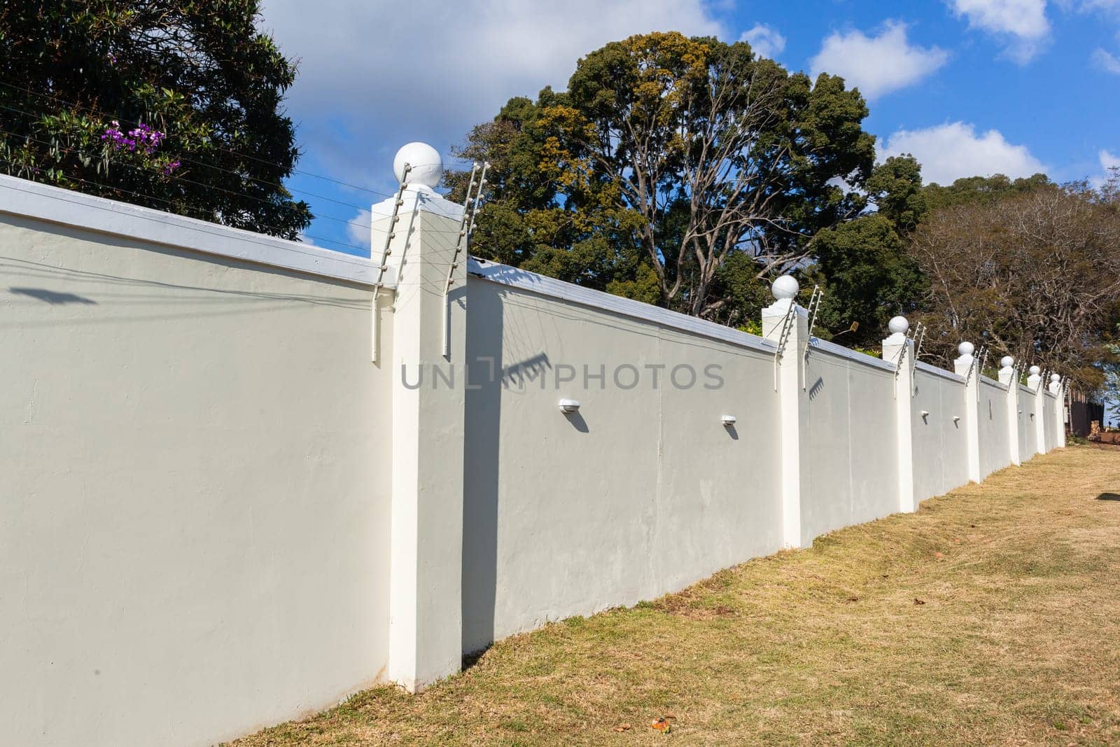 Boundary Wall high closeup with Electrified Fence for security in countryside
