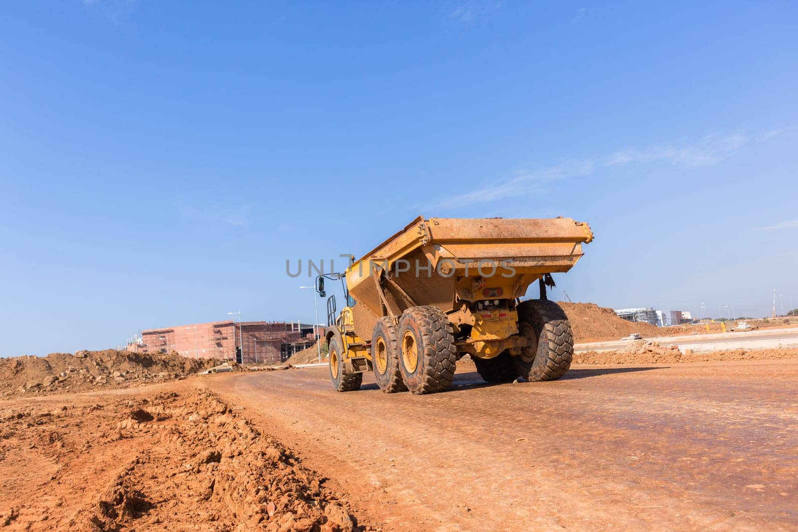 Earthworks large heavy industrial truck moving on industrial building project site