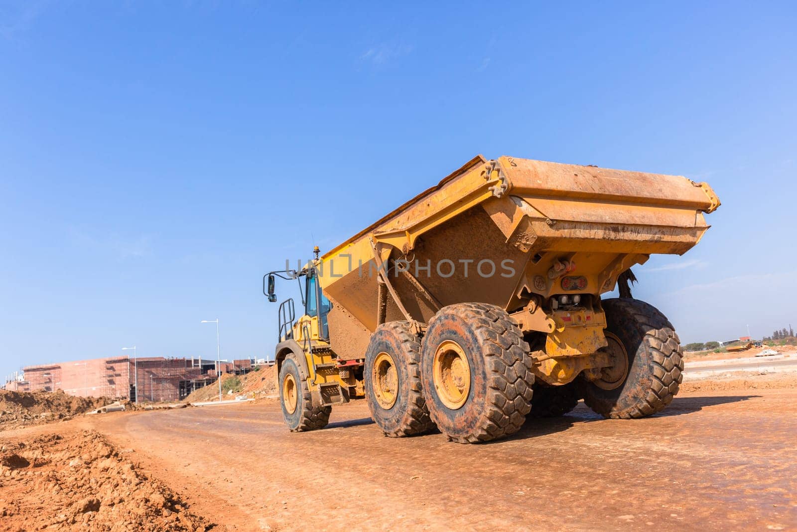 Earthworks large heavy industrial truck moving on industrial building project site