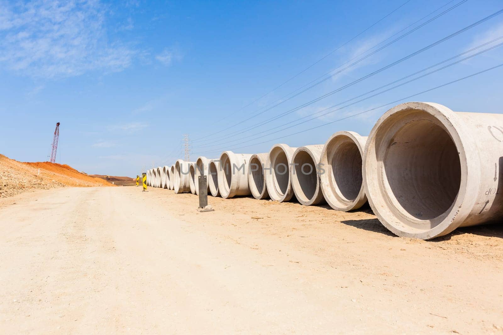 Construction new road infrastructure project development build concrete pipes earthworks industrial machines  countryside.