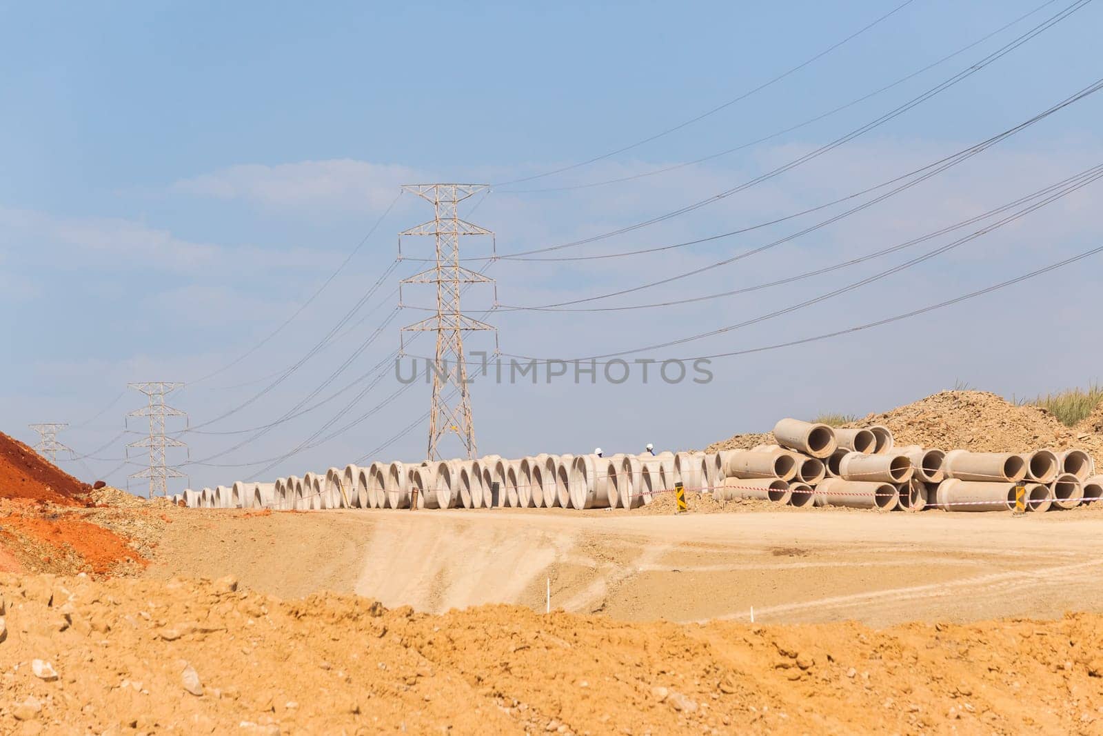 Construction new road infrastructure project development build concrete pipes earthworks industrial machines  countryside.