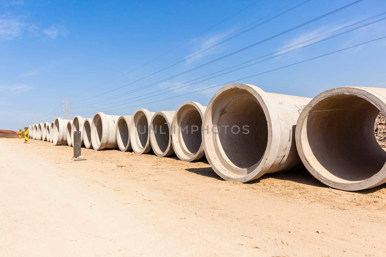 Construction new road infrastructure project development build concrete pipes earthworks industrial machines  countryside.
