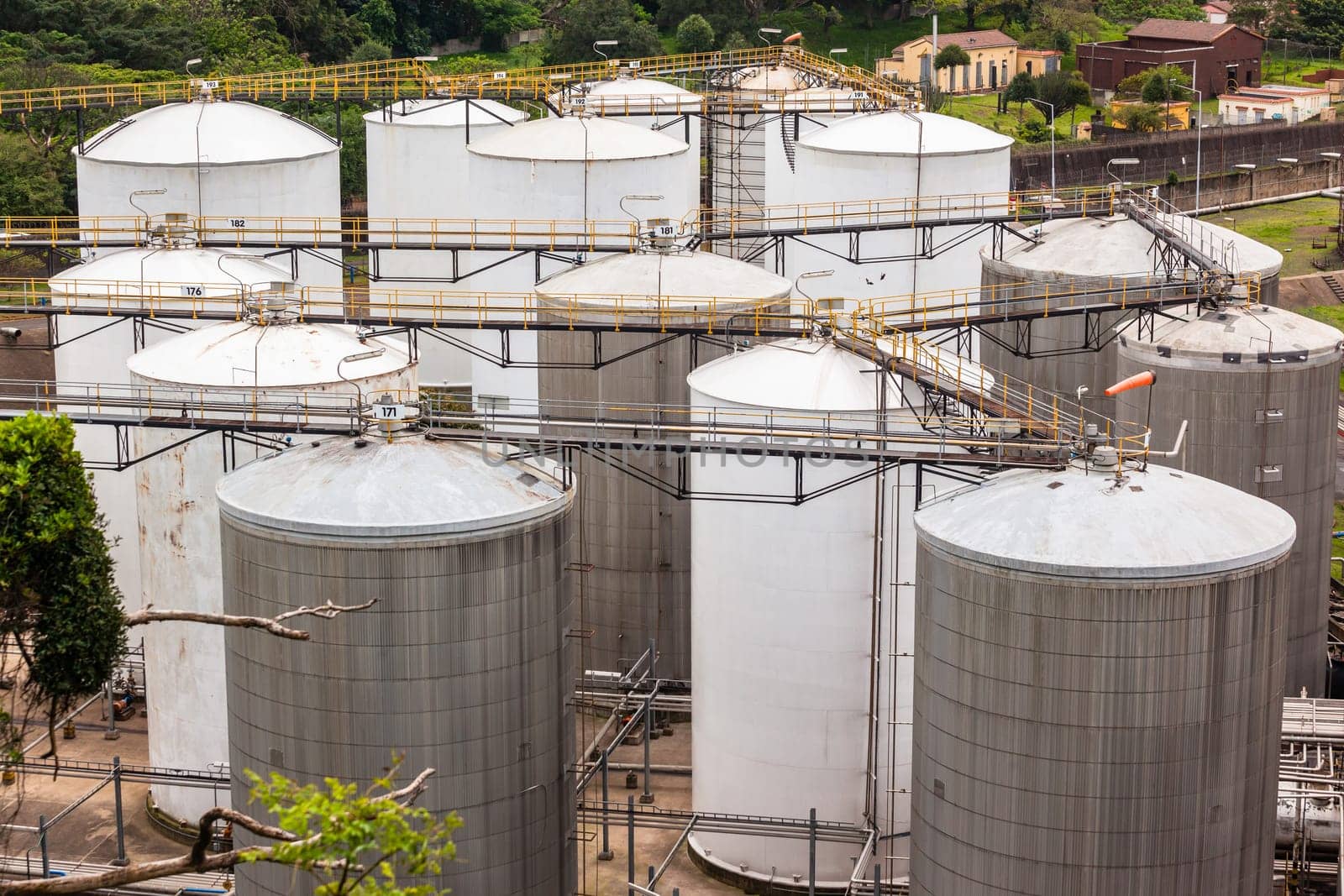 Storage steel industrial liquids oils tanks depot for fuels chemicals overlooking structures.