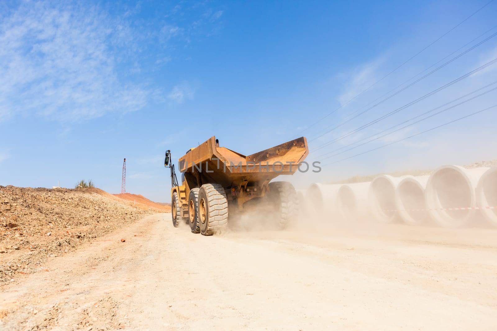 Earthworks large heavy industrial truck moving on industrial building project site