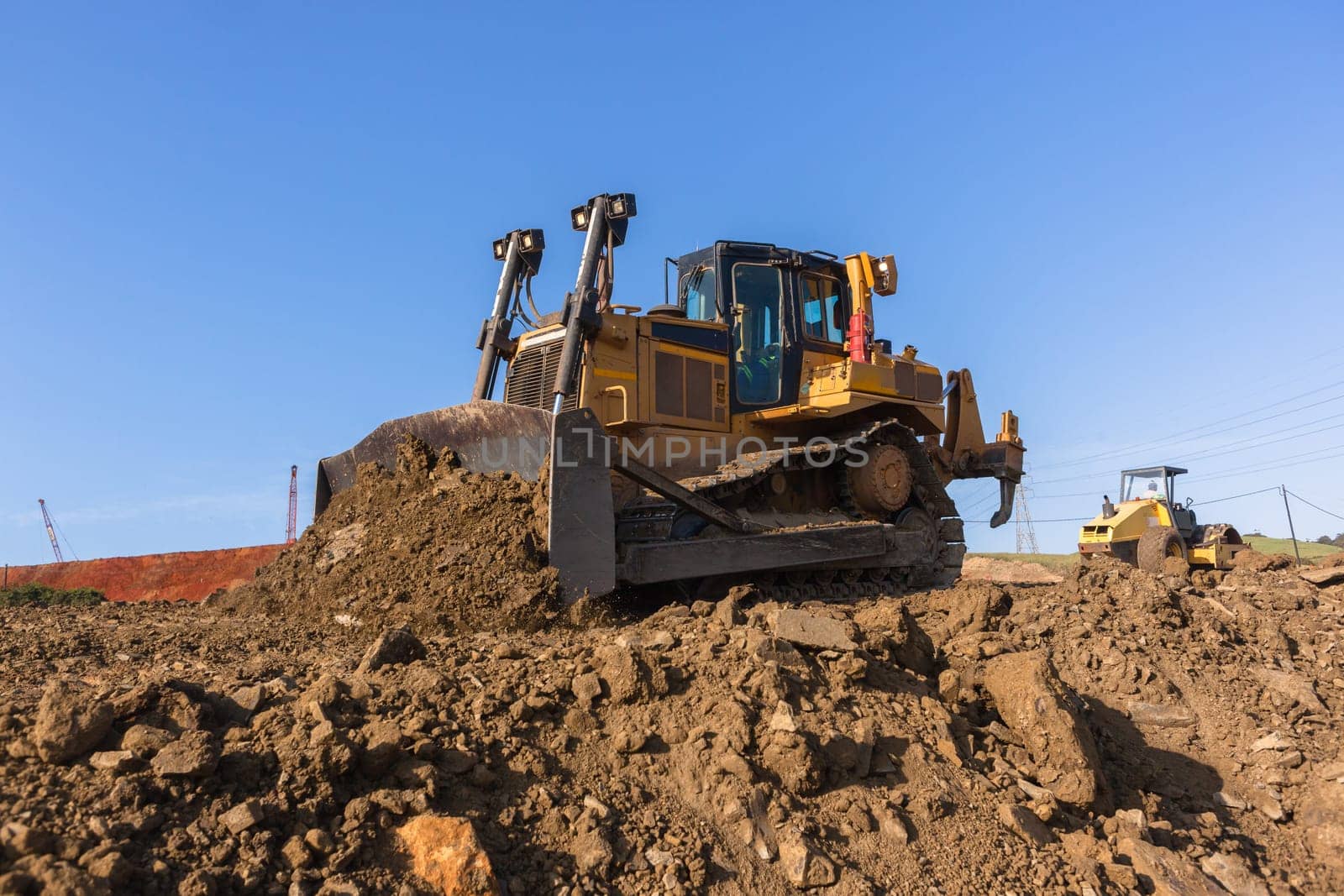 Construction industrial earthworks site  landfill grader dozer machine  leveling sand stones landscape