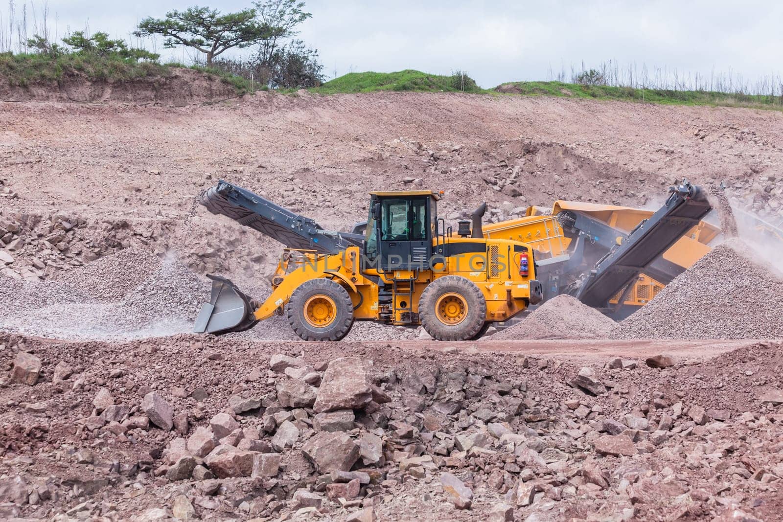 Construction mobile industrial quarry stone crushing machines producing mix grades for concrete cement on building site.