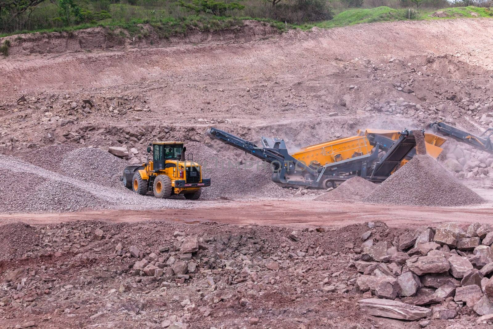 Construction mobile industrial quarry stone crushing machines producing mix grades for concrete cement on building site.