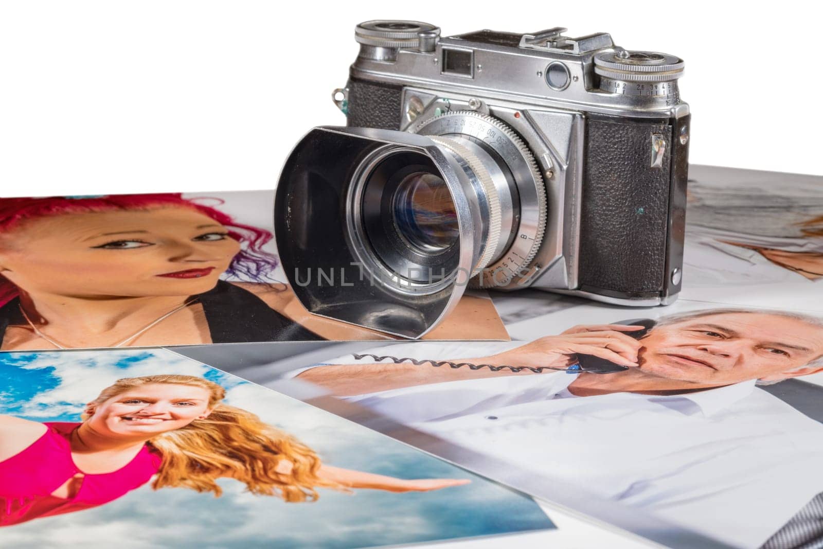 Old camera is on several pictures with portraits of people