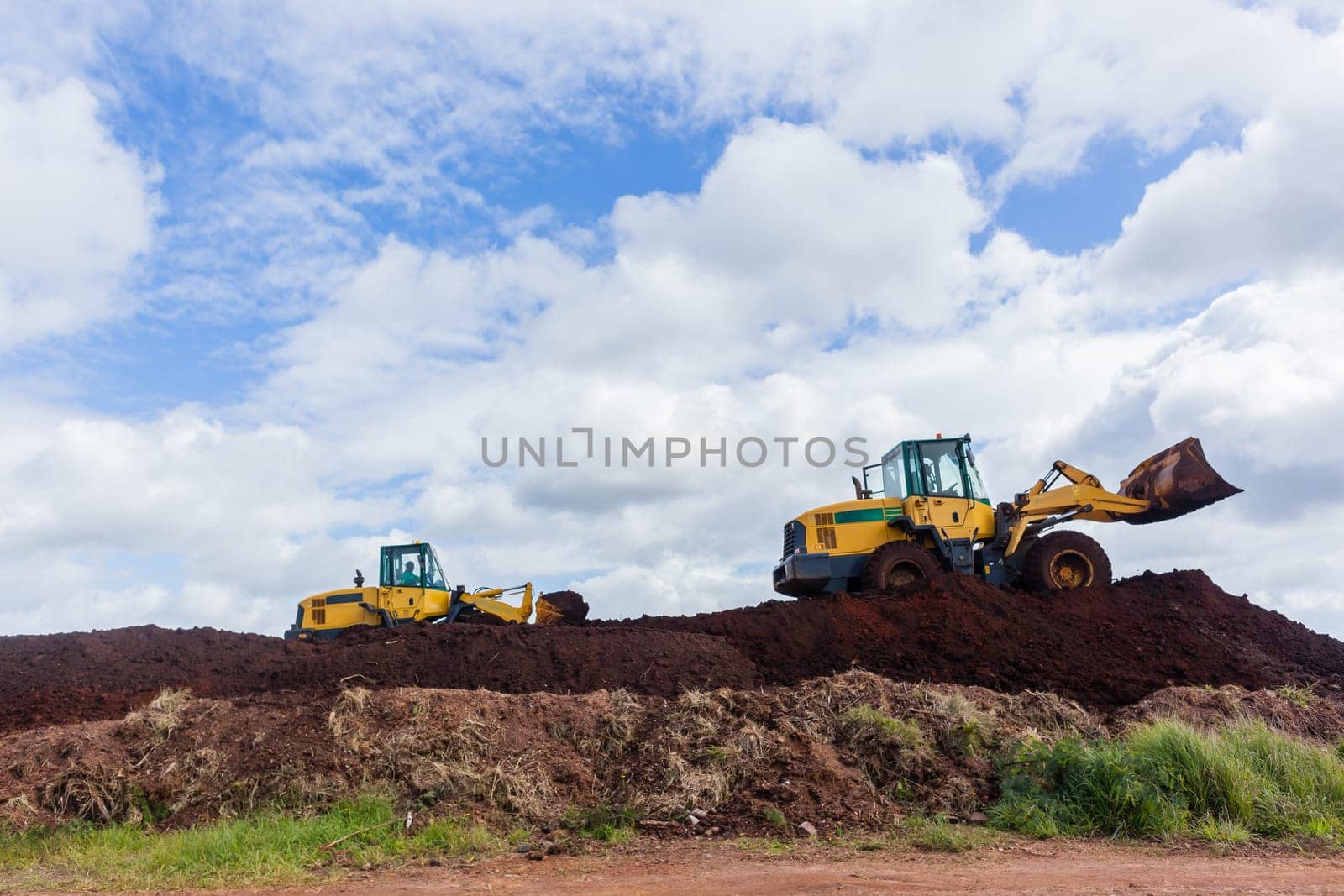 Industrial earthworks industrial vehicle loader bucket machine on building construction site.