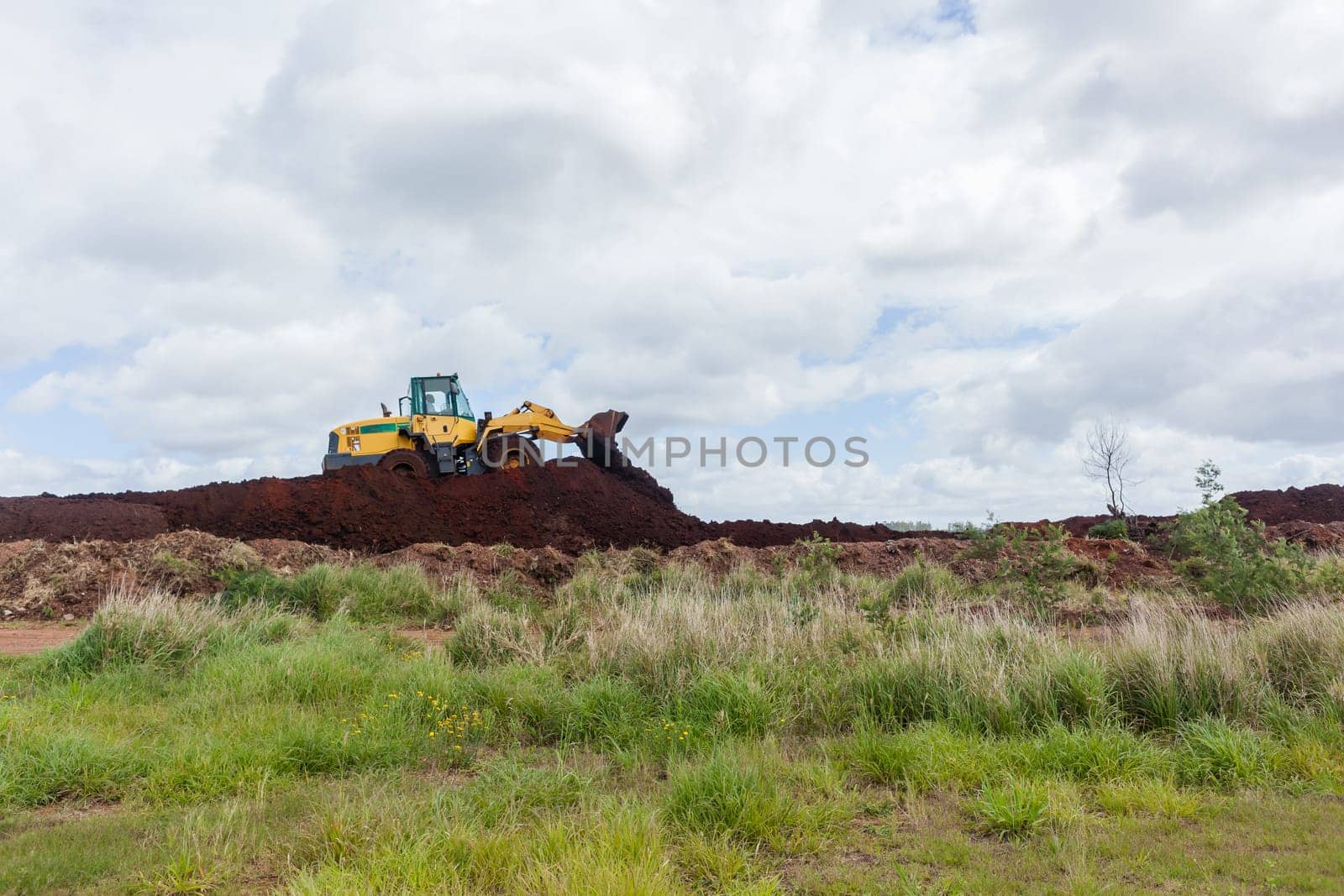 Industrial earthworks industrial vehicle loader bucket machine on building construction site.
