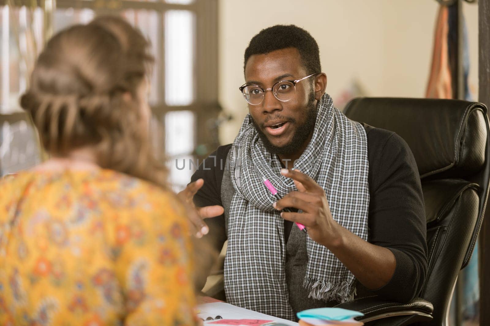 African American man in an office setting with client or coleague
