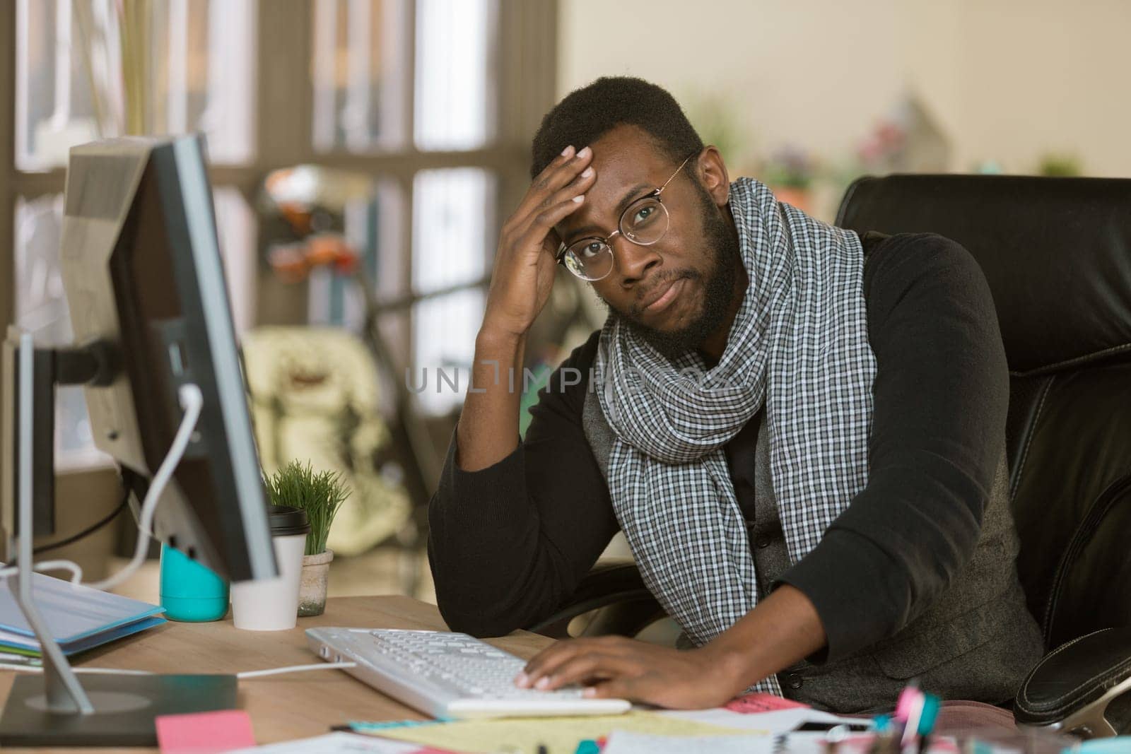 Stressed out professional man working in a creative office