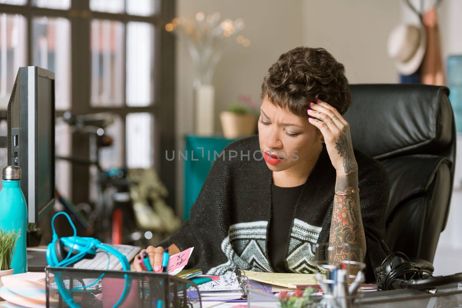 Worried or overworked professional woman in her office