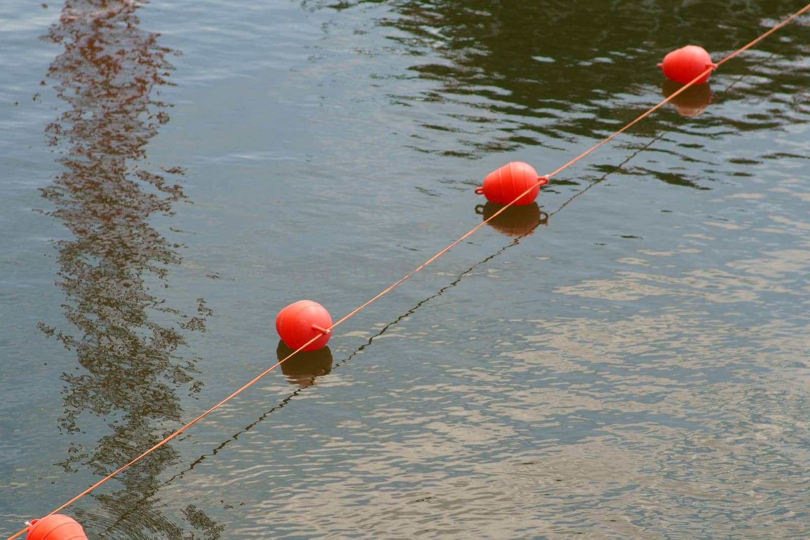 A stretched rope with juxtaposed swimming buoys to block traffic in the inland port...