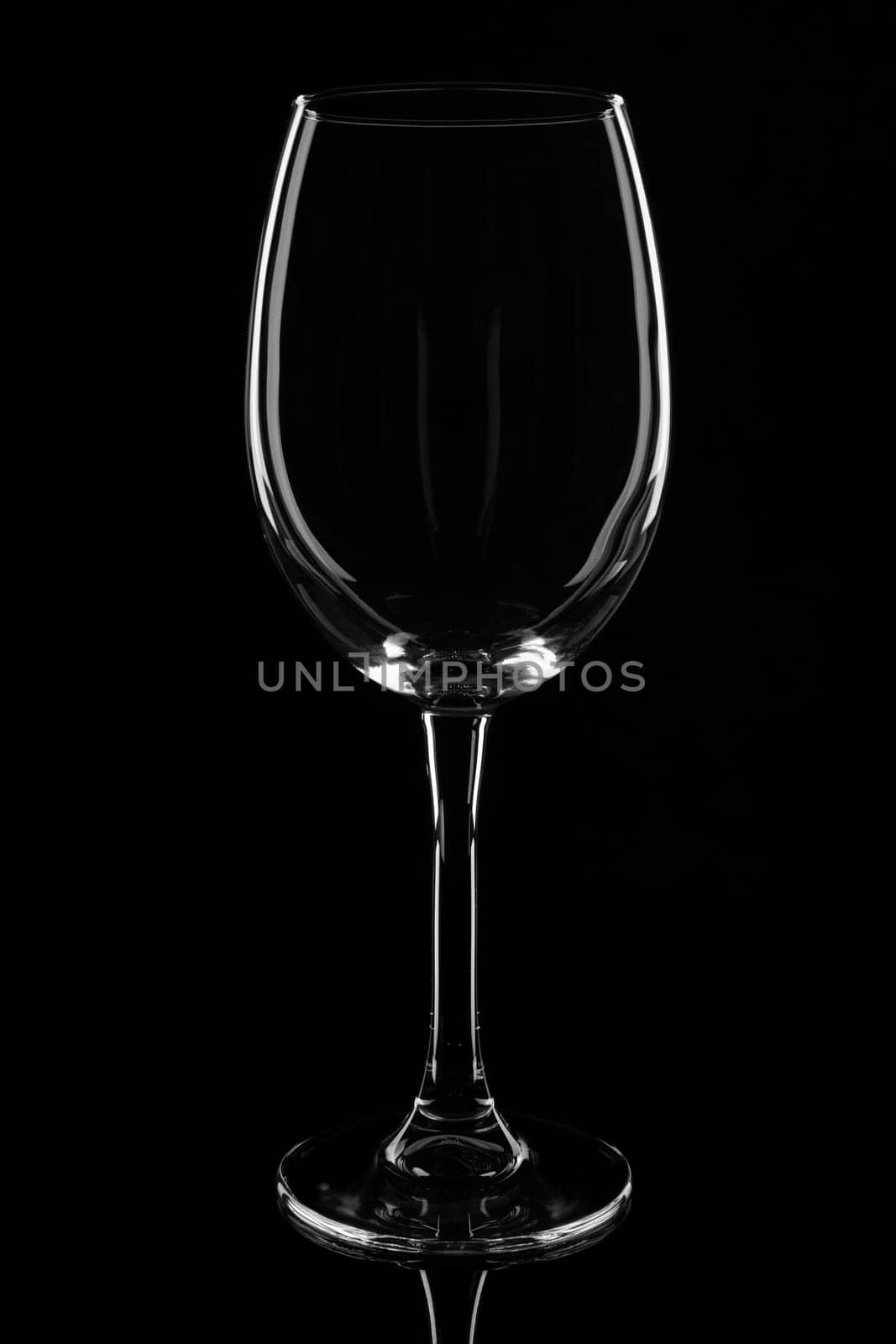 Empty clear wine glass. isolated on black background.