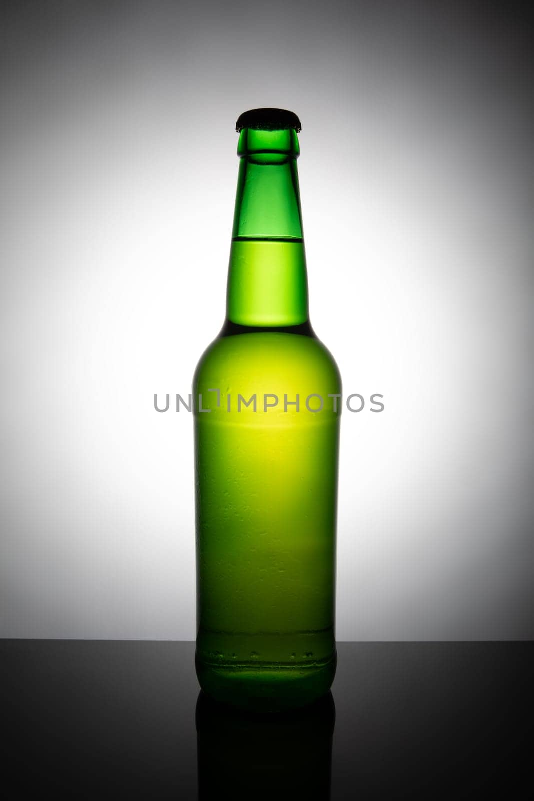 Green bottle of beer isolated on white background.