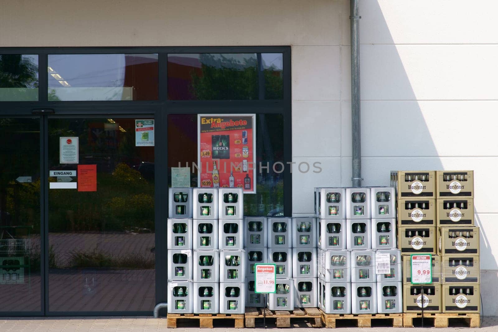 Mainz, Germany - May 24, 2019: Beverage boxes of various mineral water producers as well as beer brands in front of the entrance of the Profi beverage shop on May 24, 2019 in Mainz..