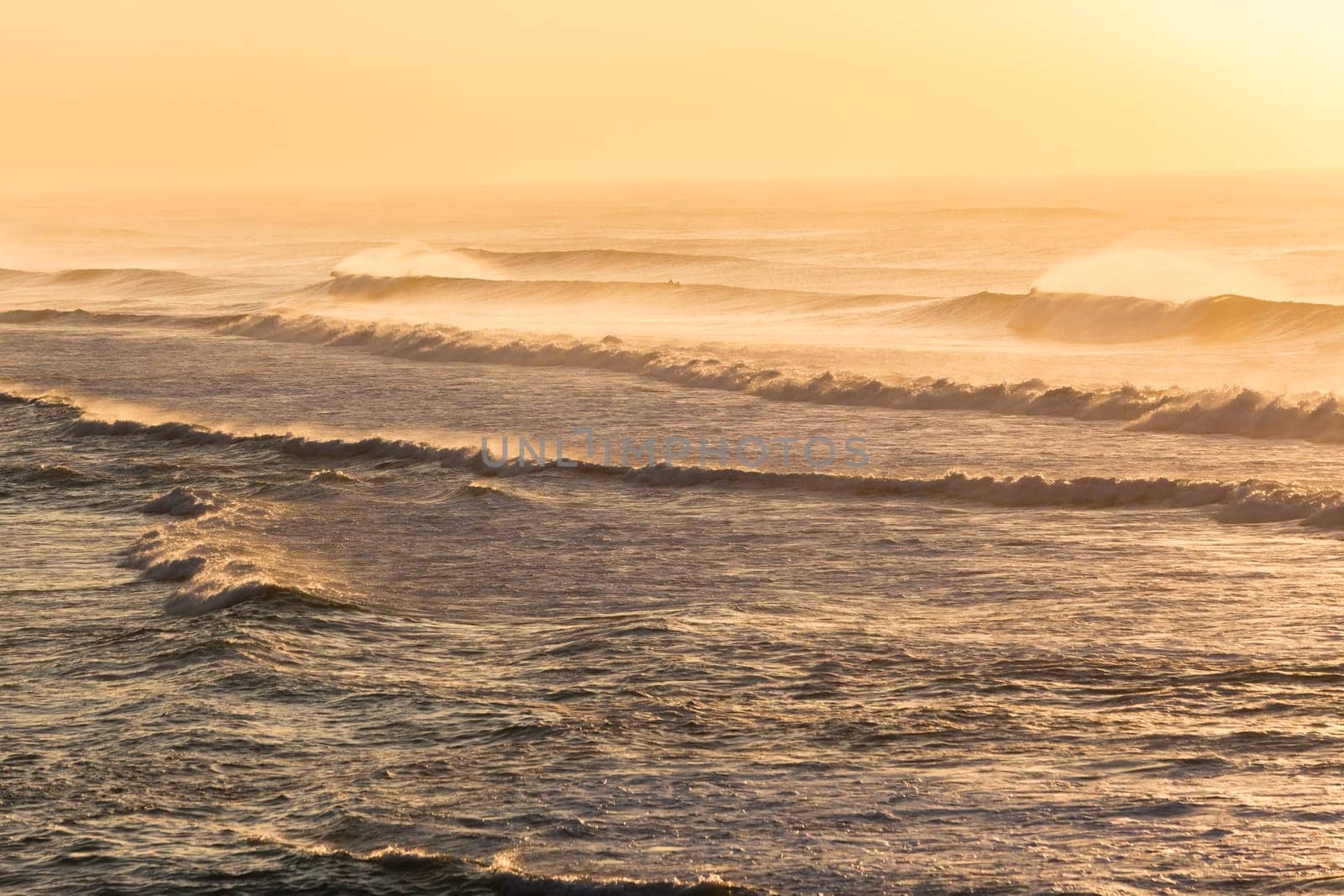 Beach ocean waves offshore winds spray morning overlooking golden color landscape