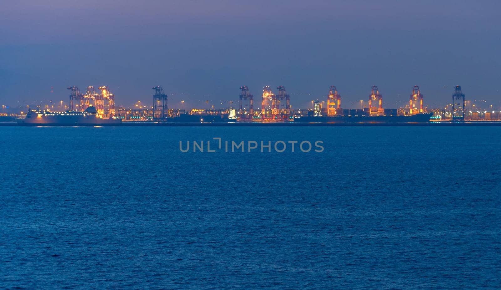 Landscape with a sea and industrial port at twilight. Barcelona, Spain
