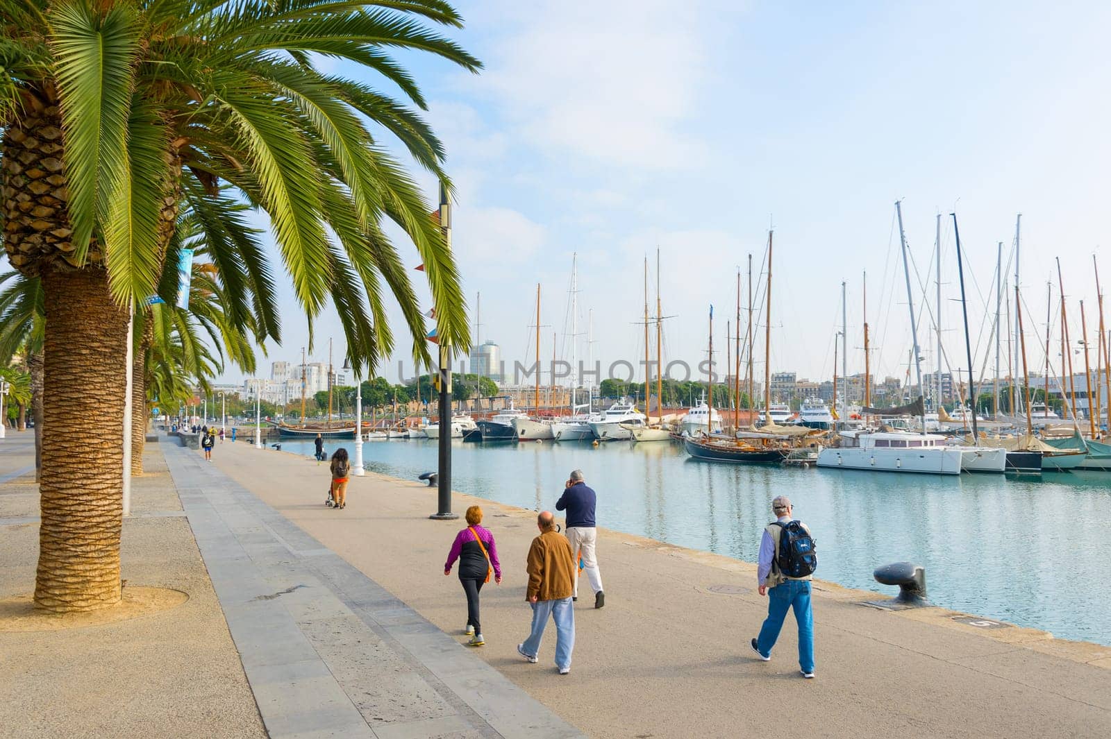 BARCELONA, SPAIN - NOVEMBER 03, 2016: People walking at Barcelona Port Vell. Port Vell is the oldest port in Barcelona. Famous tourist destination