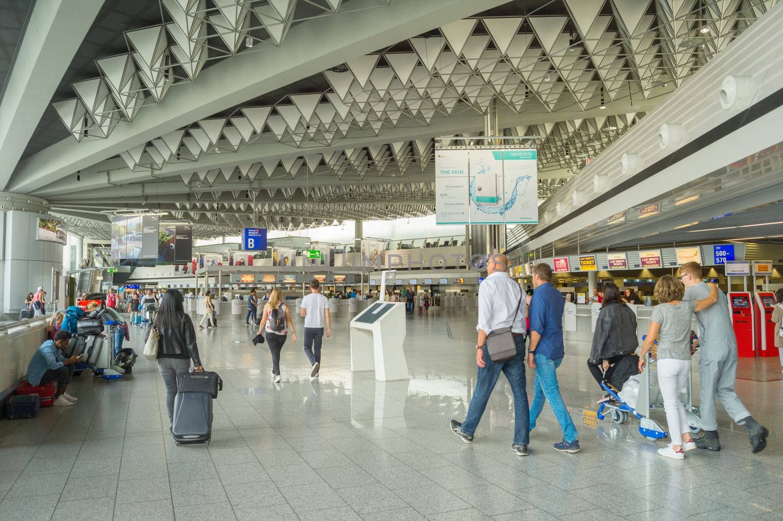 FRANKFURT, GERMANY - AUGUST 29, 2018: People at Frankfurt am Main airport hall. Frankfurt Airport is the busiest airport by passenger traffic in Germany as well as the 4th busiest in Europe