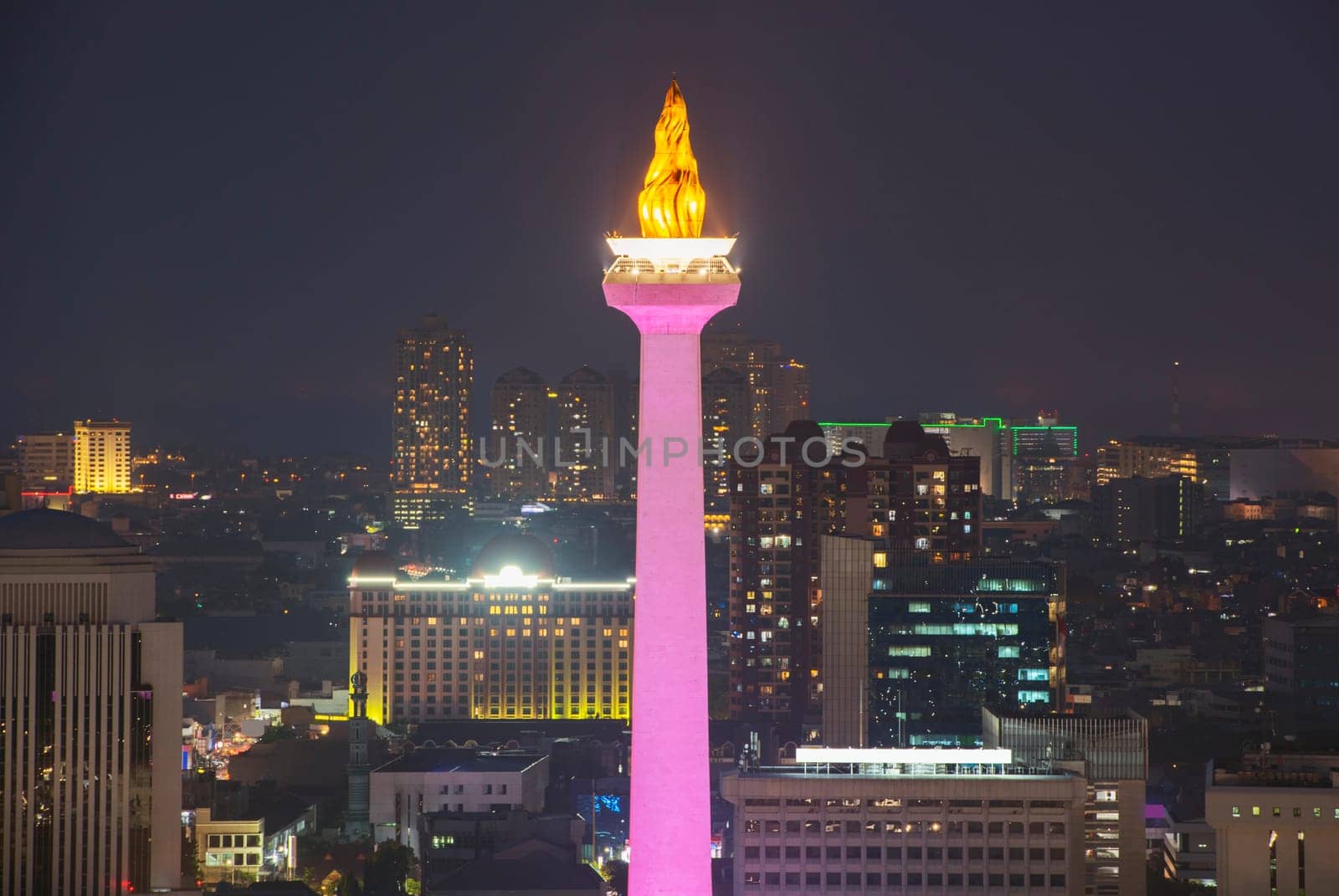 Jakarta city skyline with iconic symbol likes National Monument (Monas) at night. Jakarta, Indonesia