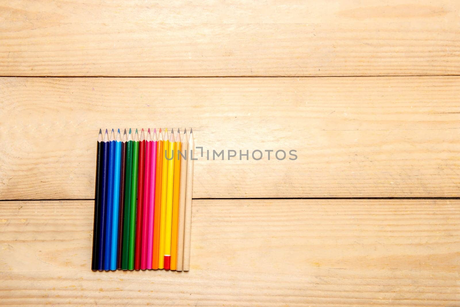 Row of colorful stationery of pencils for drawing on the wooden table. Back to School concept