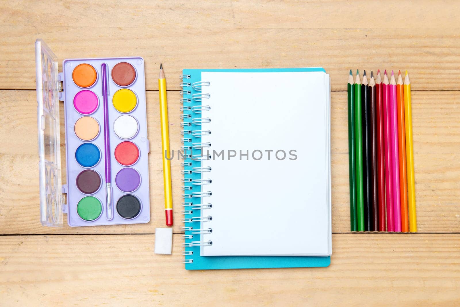 Notebooks with school supplies and stationery on the wooden table. Back to School concept