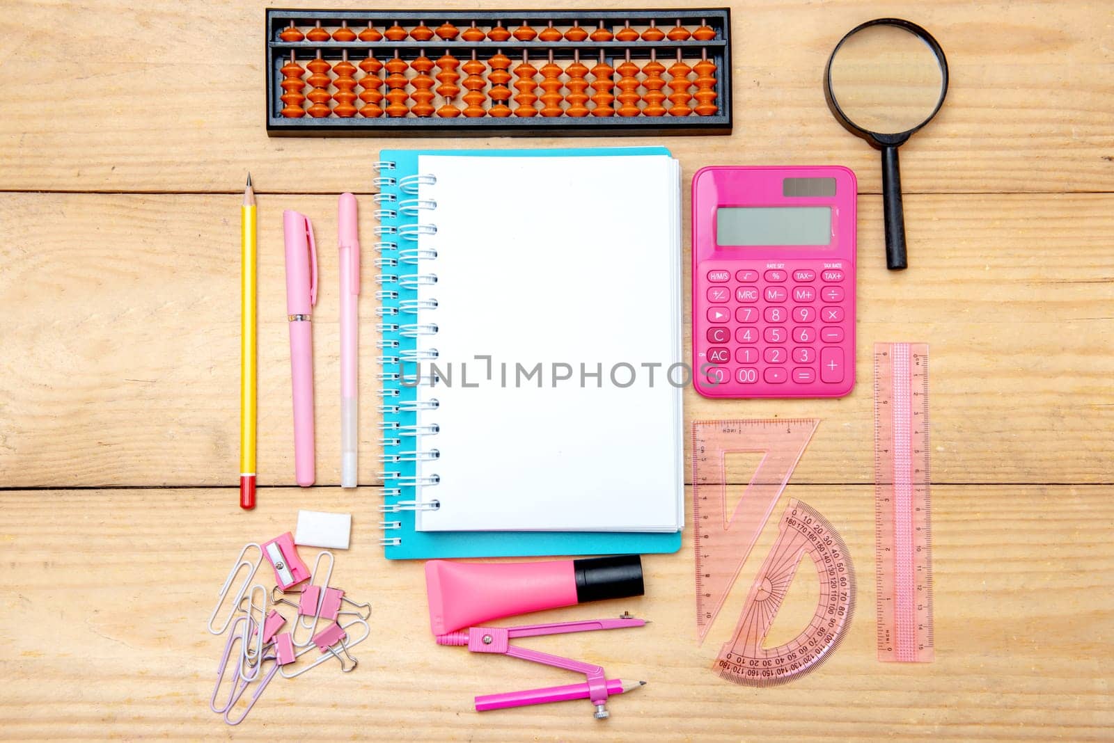Notebooks with school supplies and stationery on the wooden table. Back to School concept