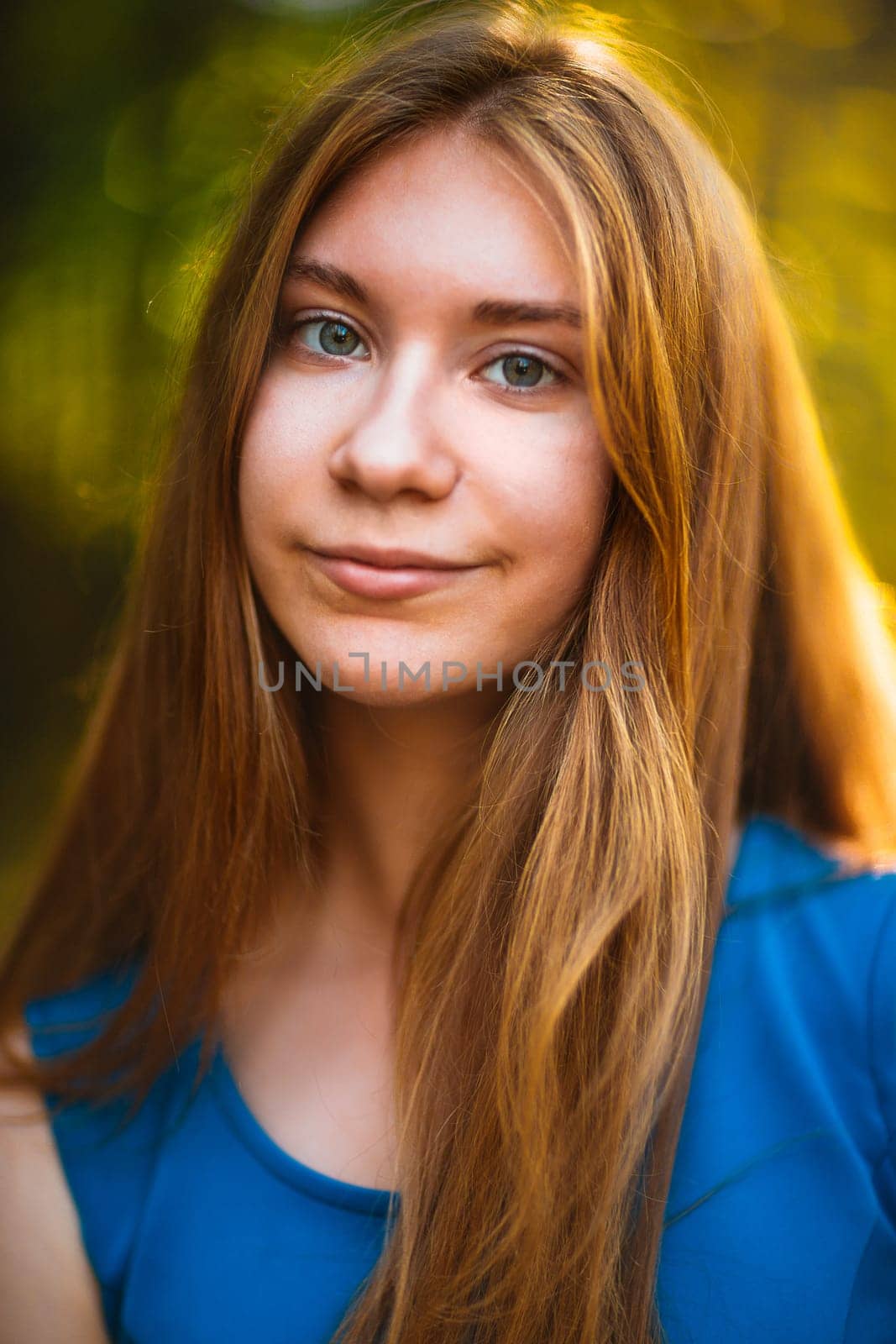 portrait of blond teenage girl on nature background.