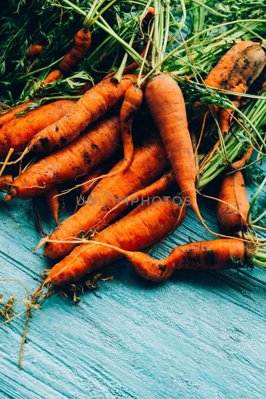 lot of carrots on a wooden background.