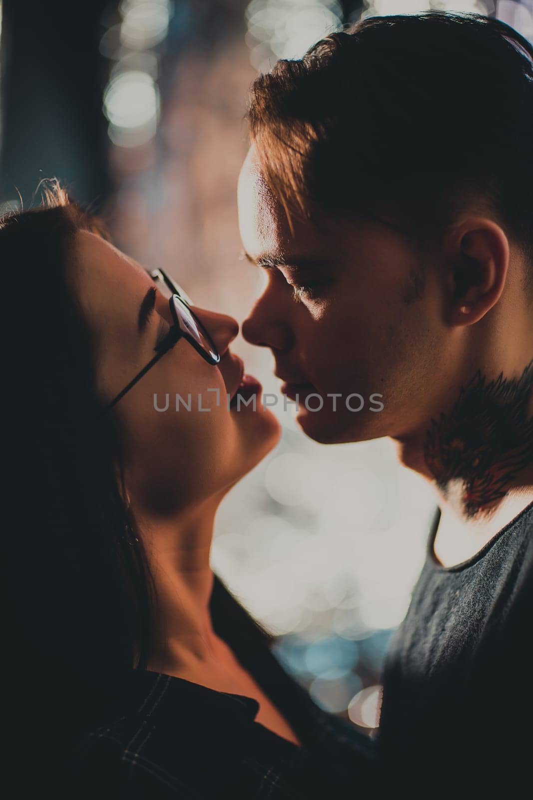 Couple in fashionable clothes on a shiny background.