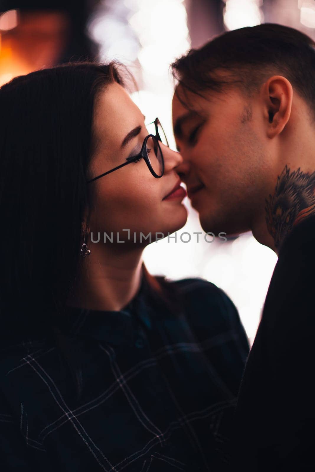 guy and the girl kiss closeup on a light background